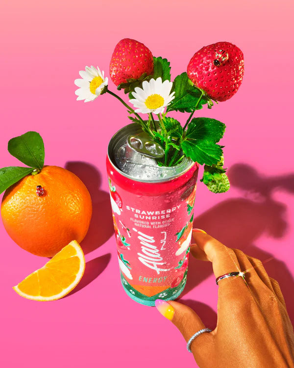 Alani Nu Strawberry Sunrise Energy Drink lifestyle photo — sugar-free 12 pack